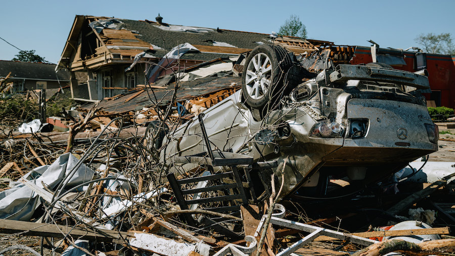 An overturned vehicle is seen on March 23 amid destroyed homes in Arabi, Louisiana. (Bryan Tarnowsk...