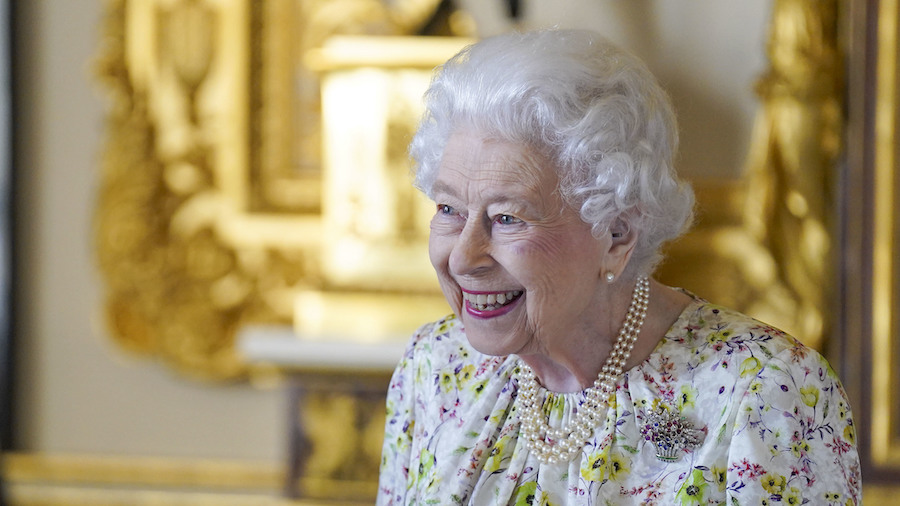 Queen Elizabeth II smiles as she arrives to view a display of artifacts from British craftwork comp...