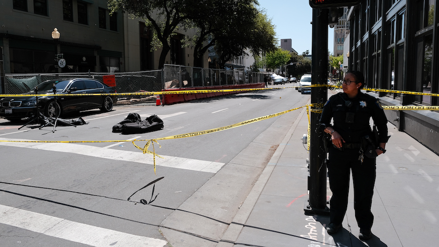 Police work the scene on the corner of 10th and J street after a shooting that occurred in the earl...