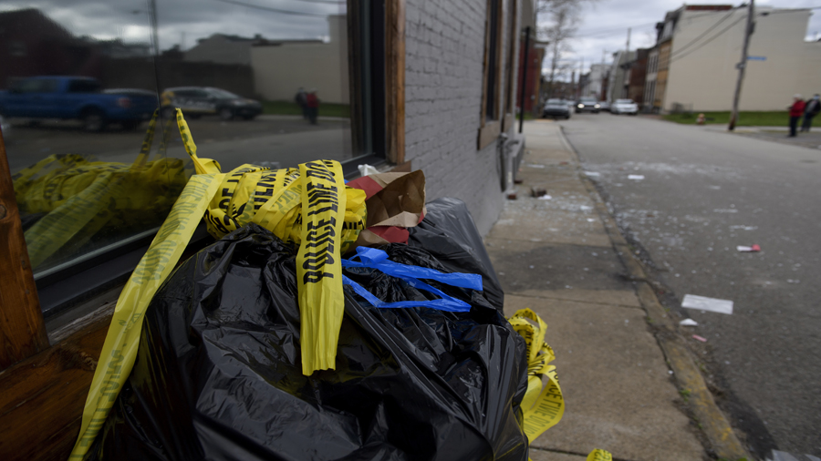 PITTSBURGH, PA - APRIL 17: Police tape, broken glass, and bloodstains outside an Airbnb apartment r...