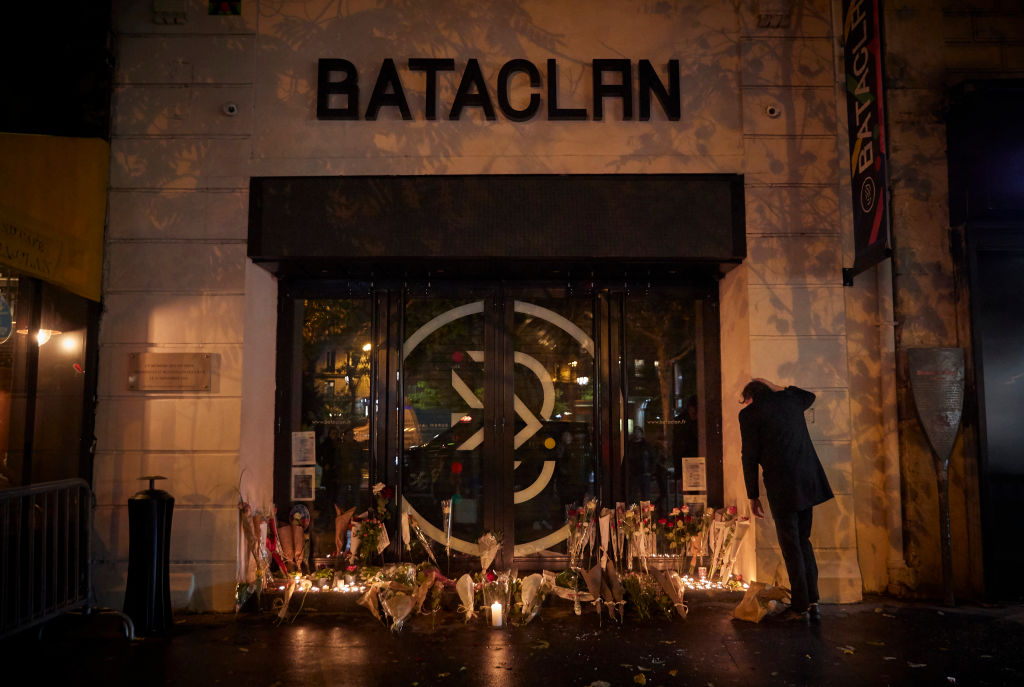 PARIS, FRANCE - NOVEMBER 13: A Parisian grieves outside the Bataclan concert hall on the sixth anni...