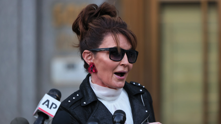 Former Alaska Governor Sarah Palin speaks with reporters as she leaves federal court on Feb. 14, 20...