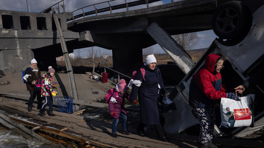 IRPIN, UKRAINE - MARCH 10: Residents of Irpin and Bucha flee fighting via a destroyed bridge on Mar...