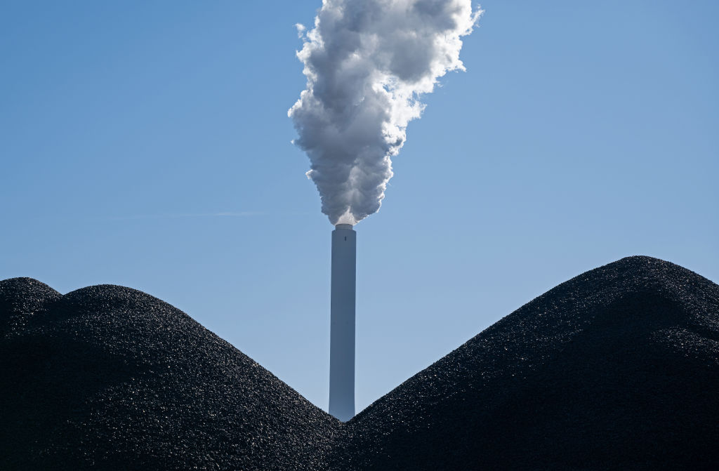 BREMEN, GERMANY - MARCH 10: A smokestack stands behind piles of coal at the coal-fired Onyx Kraftwe...
