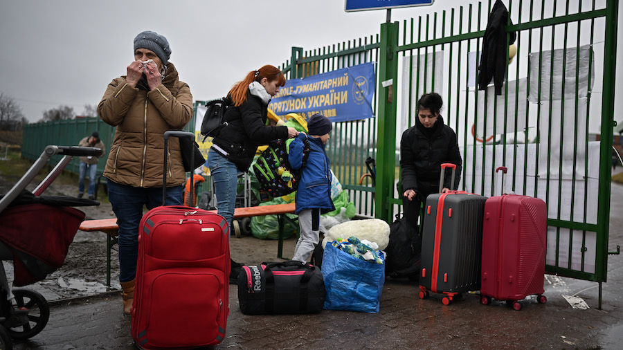 Refugees and volunteers are seen at Medyka border crossing as people pass through from war-torn Ukr...