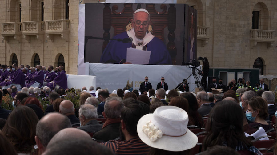 The crowd and Pope Francis broadcasted on a screen on April 3, 2022 in Valletta, Malta. Pope Franci...