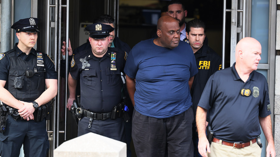 Suspect Frank James is led by police from Ninth Precinct after being arrested for his connection to...