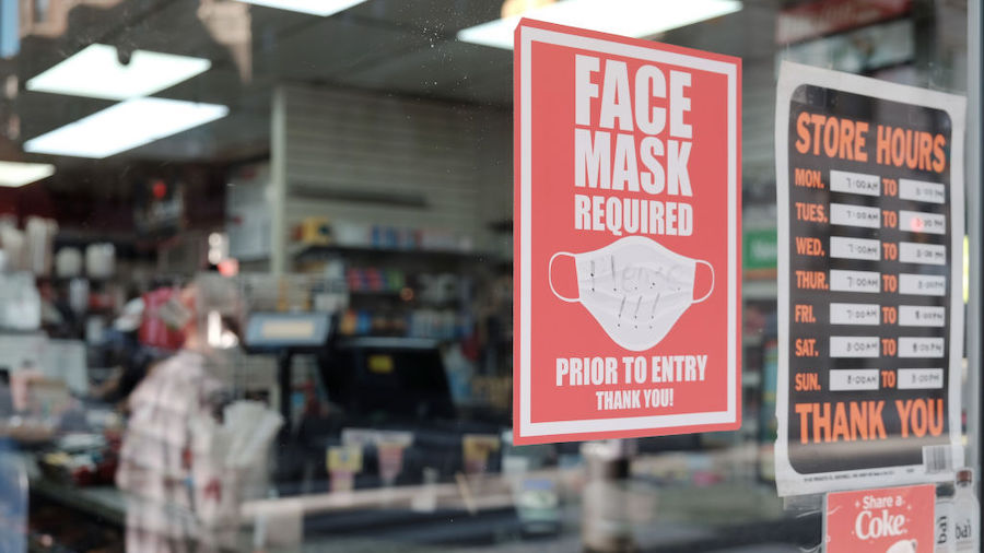 A sign on a door asks people to wear masks in downtown  on April 15, 2022 in Philadelphia, Pennsylv...