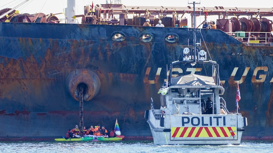 A police boat is pictured at the scene as members of Greenpeace stage a protest against the Ust Lug...