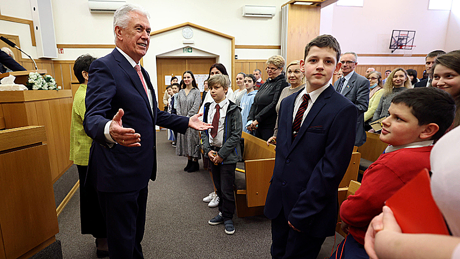 Elder Dieter F. Uchtdorf greets Ukrainian refugees at a meeting for youth in Warsaw, Poland, on Sun...