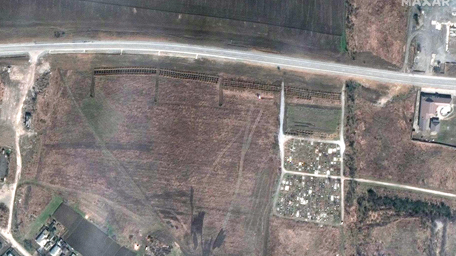 A satellite image from  April 3 shows what appears to be a newly dug mass grave site, next to the c...
