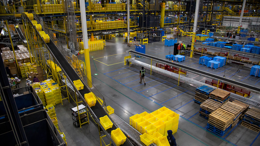 Bins move along a conveyor at an Amazon fulfillment center on Cyber Monday in Robbinsville, New Jer...