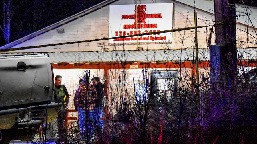 Law enforcement agents are seen outside the Lock Stock & Barrel shooting range where the shooting h...