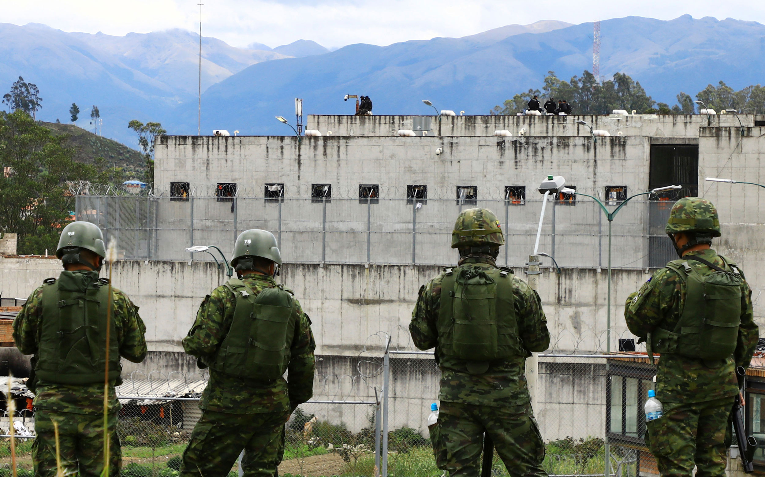 Soldiers stand guard outside Turi prison after a deadly prison riot in Cuenca, Ecuador, Sunday, Apr...