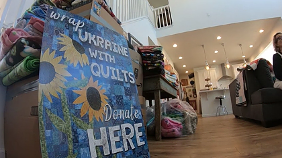 Quilts bound for Ukraine are stacked in the Lehi home of Gina and Hall Halladay. (KSL TV)...