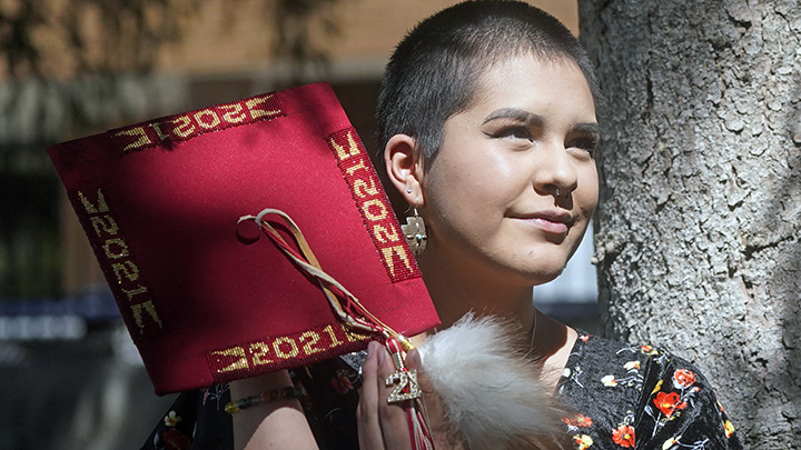 Emalyce Kee, a Navajo and Rosebud Sioux, holds her 2021 beaded graduation cap Wednesday, May 25, 20...