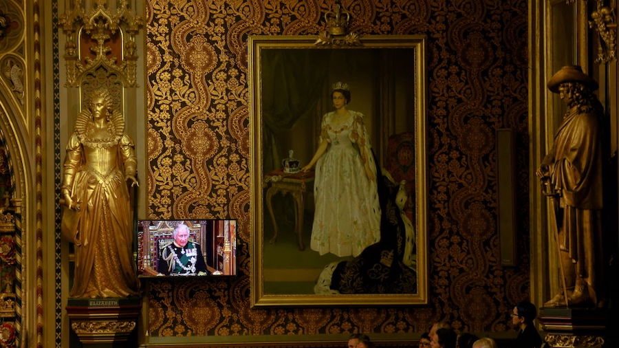 Prince Charles appears on a screen next to a painting of Queen Elizabeth at the Royal Gallery as he...