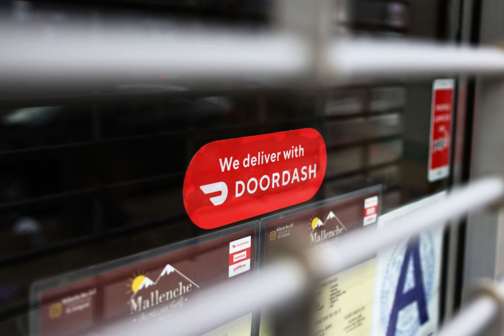 NEW YORK, NEW YORK - DECEMBER 04: A Doordash sticker is seen on a window at Mallenche Mexican Grill...