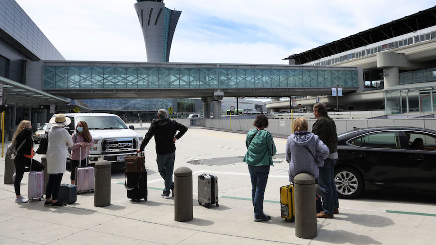 Passengers wait for transportation at San Francisco International Airport on May 12, 2022 in San Fr...