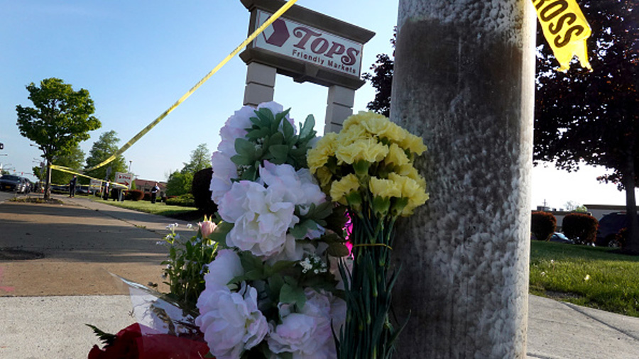 BUFFALO, NEW YORK - MAY 15:  Flowers are left at a makeshift memorial outside of Tops market on May...