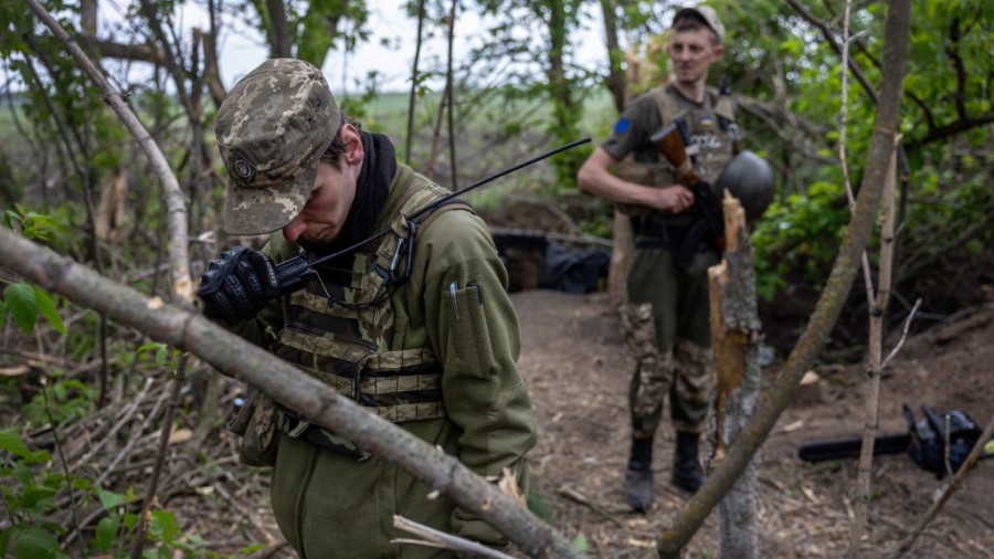 KHARKIV OBLAST, UKRAINE - MAY 20: A Ukrainian Army officer speaks by radio on a frontline position ...