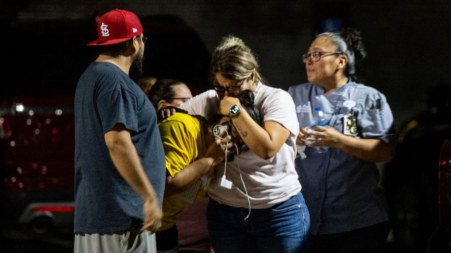 A family grieves outside of the SSGT Willie de Leon Civic Center following the mass shooting at Rob...