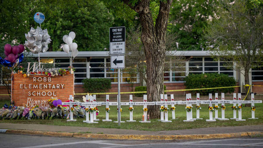 A memorial is seen surrounding the Robb Elementary School sign following the mass shooting at Robb ...