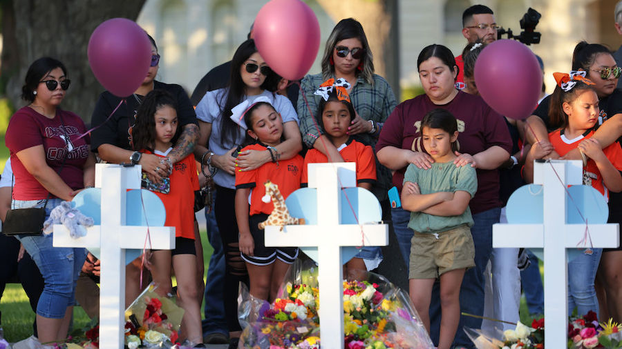 People visit memorials for victims of Tuesday's mass shooting at a Texas elementary school, in City...