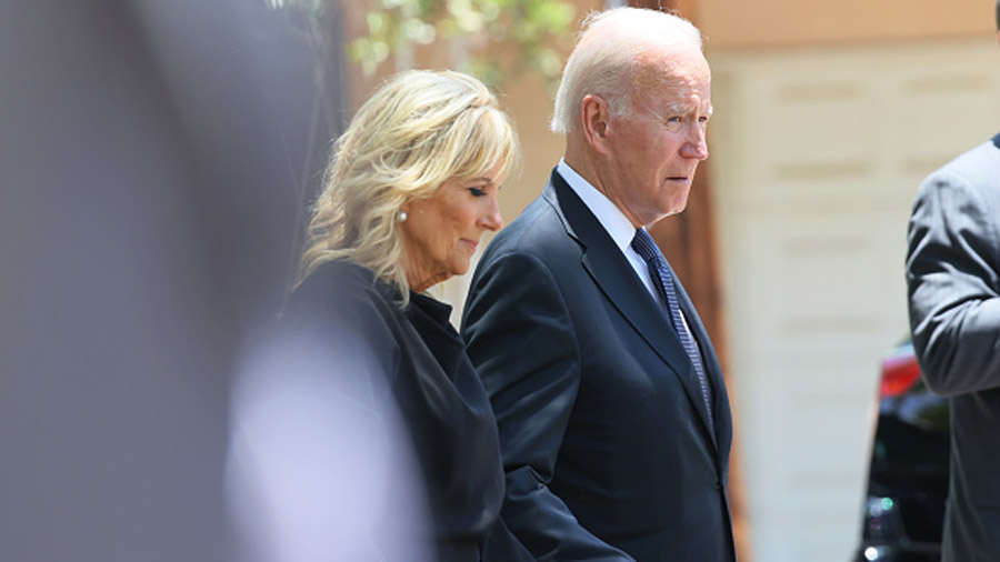 First Lady Dr. Jill Biden and President Joe Biden walk towards their car after attending mass at Sa...