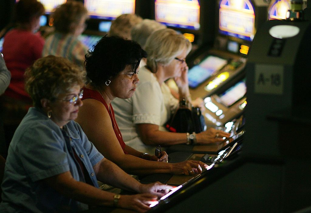 HALLANDALE BEACH, FL - NOVEMBER 15:  Patrons test their luck with a card game slot machine at the r...