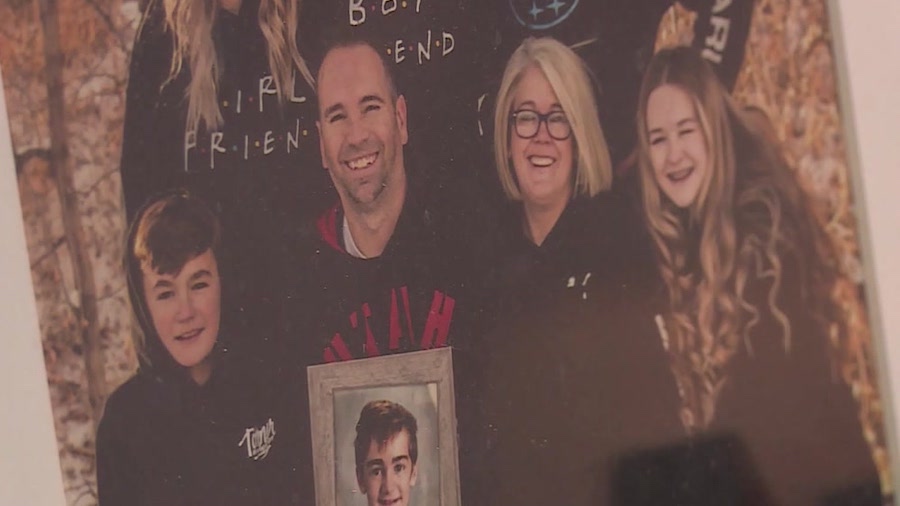 The Buck family holds up a picture of their son, Greysen Buck, who was hit and killed by a car in 2...