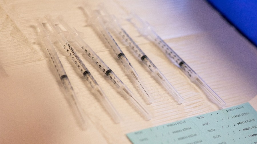 Syringes ready to be administered to residents who are over 50 years old and immunocompromised and ...
