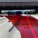 The non-hazardous red fluid across 3300 South under I-15. (Credit: Utah Highway Patrol)  