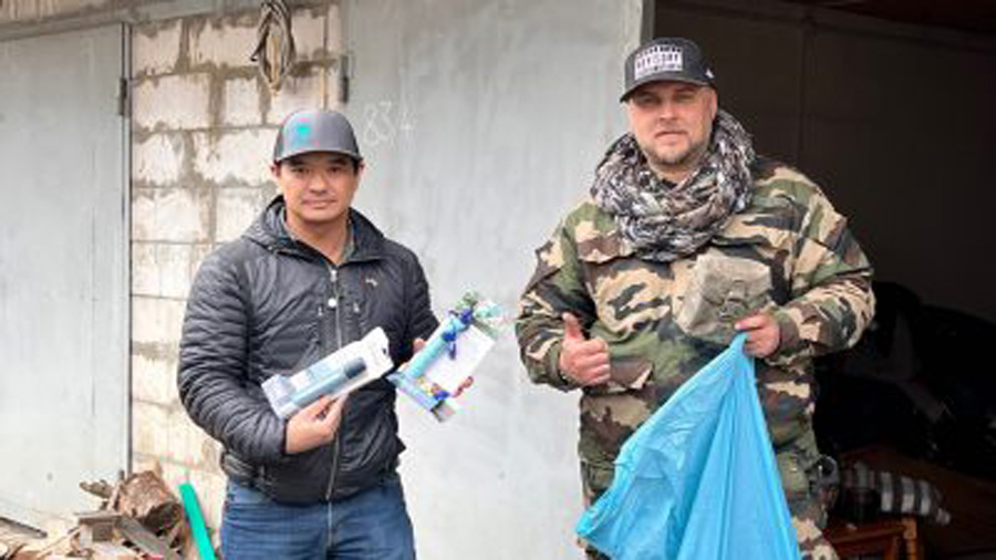 Quan Nguyen, a marine veteran from Kaysville, and a friend of his hold water purification pens that...