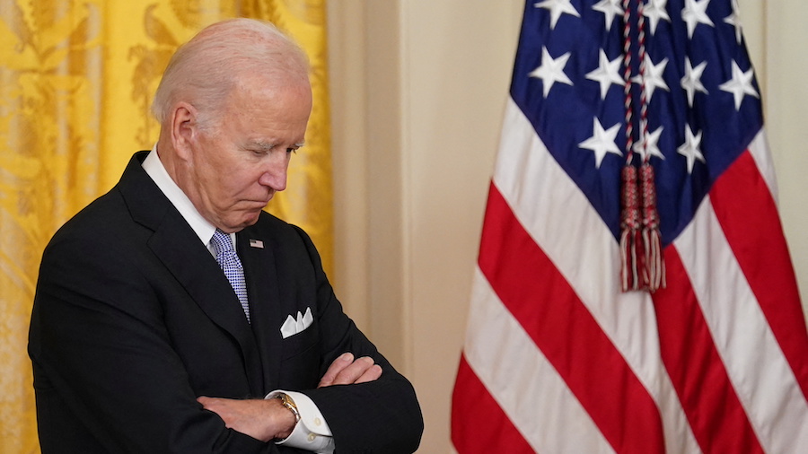 U.S. President Joe Biden listens ahead of the signing of an executive order to reform federal and l...