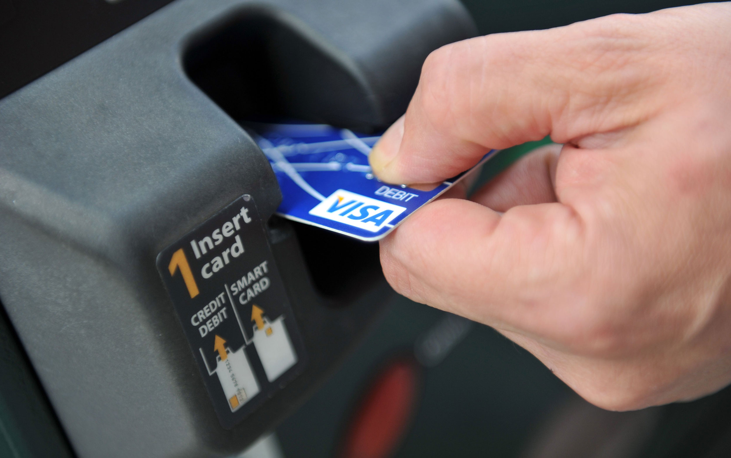 A credit card is swiped at a parking meter on August 20, 2010 in Washington. New rules issued by th...