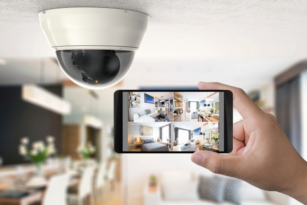 hand holding 3d rendering mobile connect with security camera for security solutions