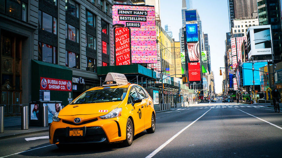 A taxi drives down Times Square on March 26, 2020 in New York City. Most cabdrivers are fearful of ...