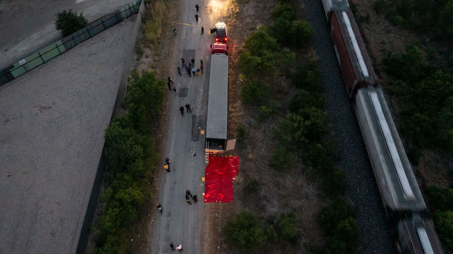 In this aerial view, members of law enforcement investigate a tractor trailer on June 27, 2022 in S...