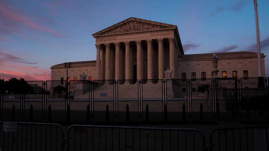 The sun sets in front of the Supreme Court on June 28, 2022 in Washington, D.C. (Photo by Nathan Ho...