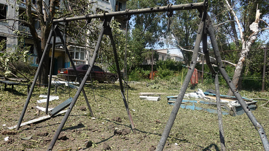 BAKHMUT, UKRAINE - JUNE 13: Holes are burned through a charred swing set from shrapnel after a proj...