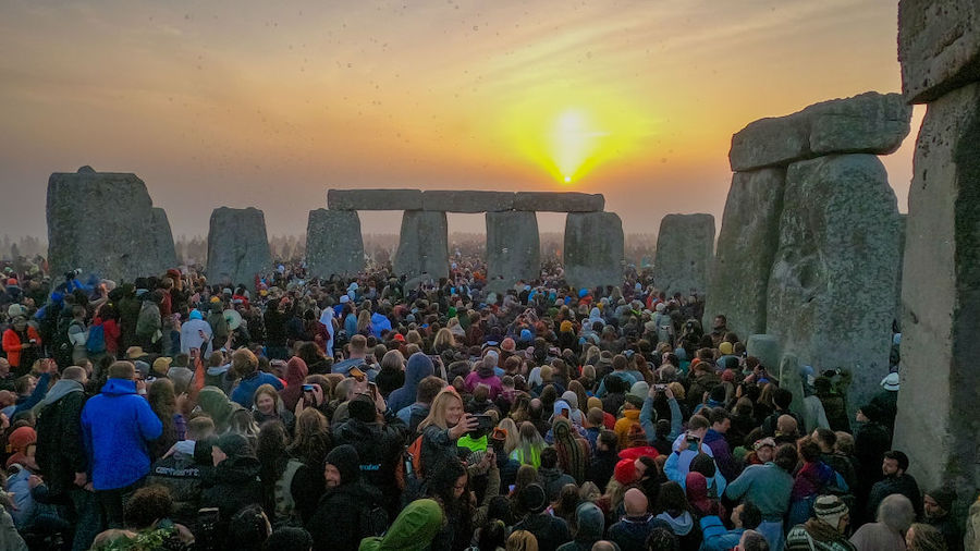 People gather for sunrise at Stonehenge, on June 21, 2022 in Wiltshire, England. The summer solstic...
