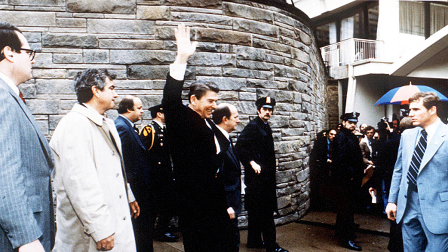 President Ronald Reagan waves to onlookers moments before an assassination attempt by John Hinckley...