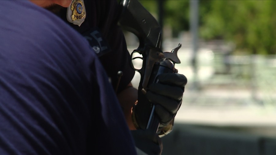 A Salt Lake City police officer handling a revolver that's being turned in....