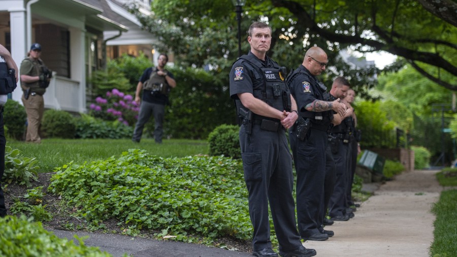 Police officers stand outside the home of U.S. Supreme Court Justice Brett Kavanaugh in anticipatio...