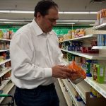 KSL’s Matt Gephardt picks up a package of ramen noodles to price compare with other grocery stores. (Josh Szymanik, KSL TV)