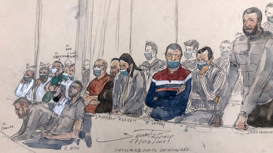 This court-sketch made on Monday shows defendant Salah Abdeslam (right) standing next to the 13 oth...