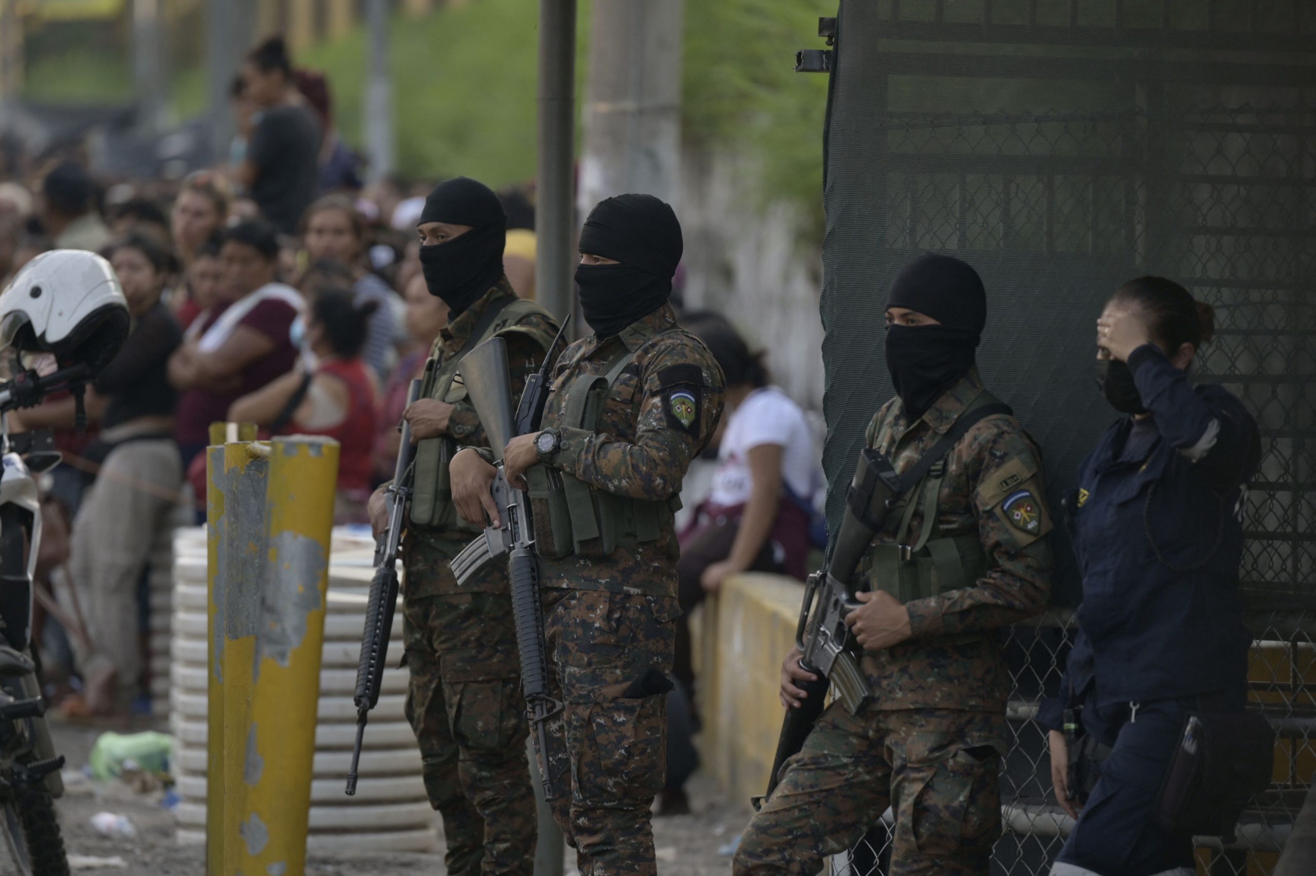 Salvadoran soldiers guard the outskirts of La Esperanza prison while relatives of men with suspecte...