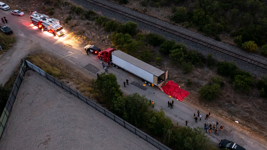 In this aerial view, members of law enforcement investigate a tractor trailer on June 27 in San Ant...