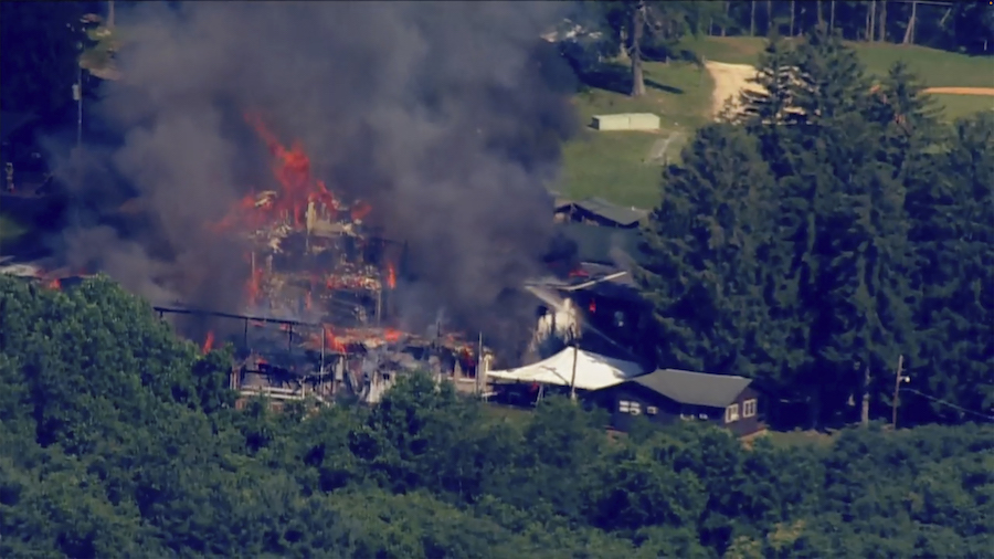 This image taken from video provided by WJLA shows crews battling a large fire at Camp Airy for Boy...